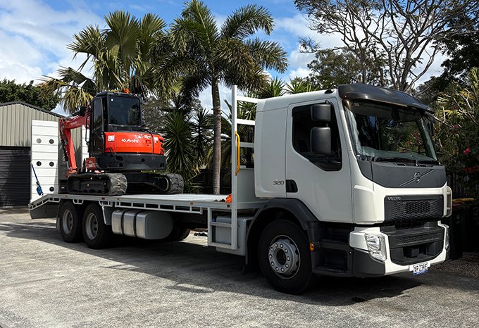 Boss Brick and Block truck floating an excavator